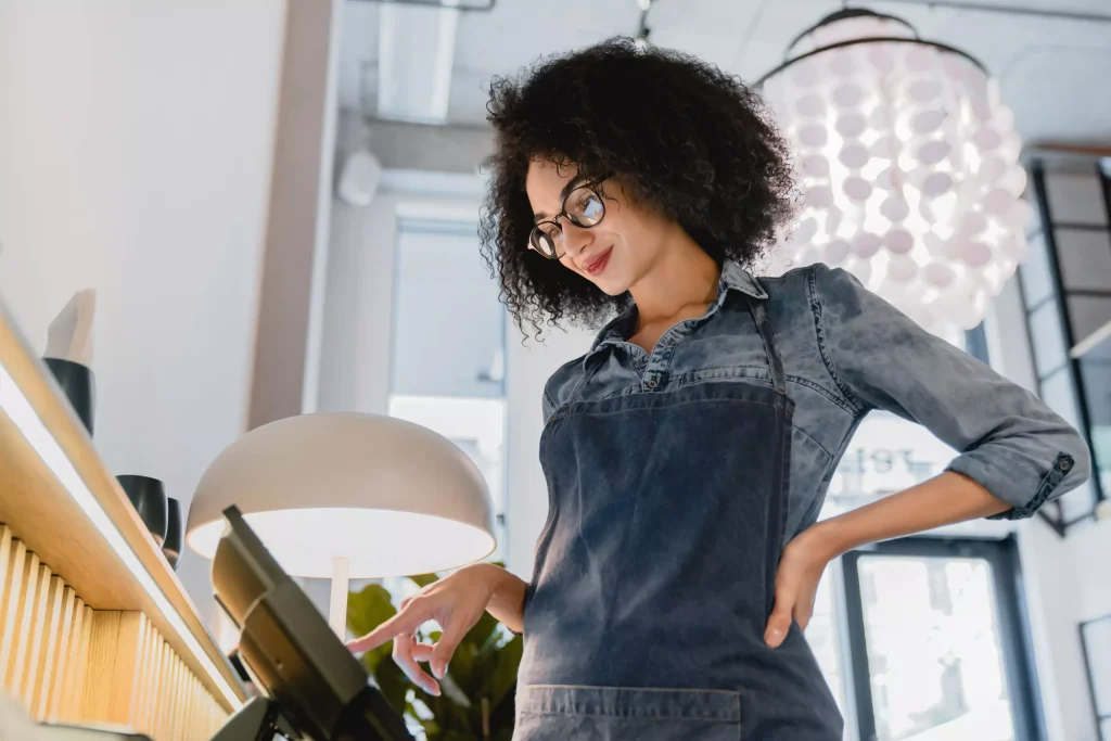 Smiling woman using restaurant POS system