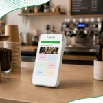 A portable POS terminal, called Sapaad Go, sitting on the counter top of a cafe showing the Sapaad POS interface.